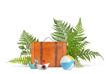 Brown travel suitcase, tropical leaves, beach ball, toy anchor and paper boat on white background