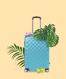 Image of Light blue travel suitcase, tropical leaves and flowers on beige background