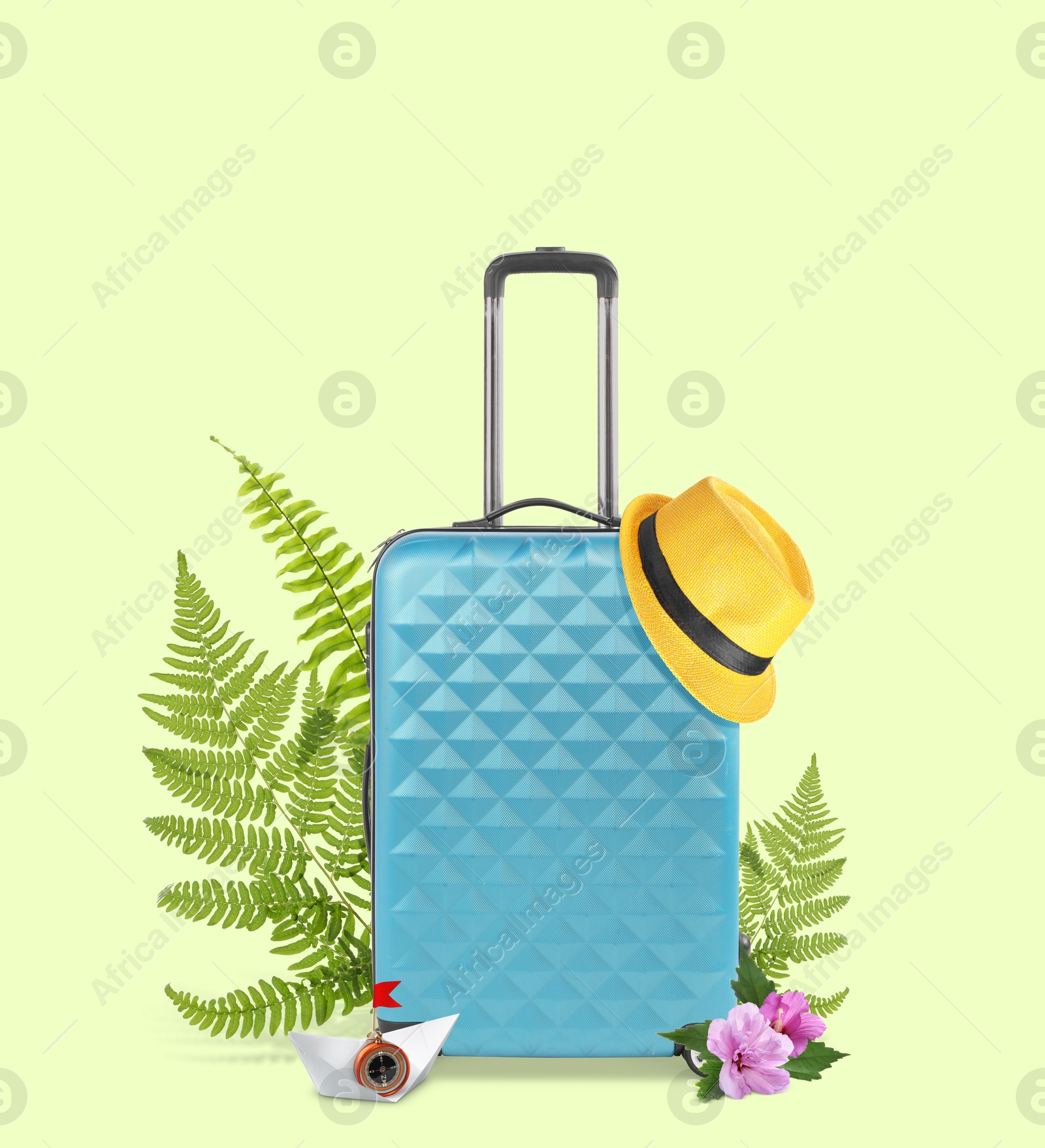 Image of Light blue travel suitcase, hat, paper boat, tropical leaves and flowers on light green background