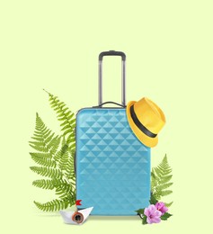 Image of Light blue travel suitcase, hat, paper boat, tropical leaves and flowers on light green background