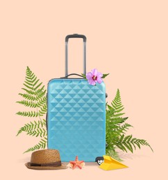 Image of Light blue travel suitcase, hat, paper plane, sea star, seashell, tropical leaves and flower on pink beige background