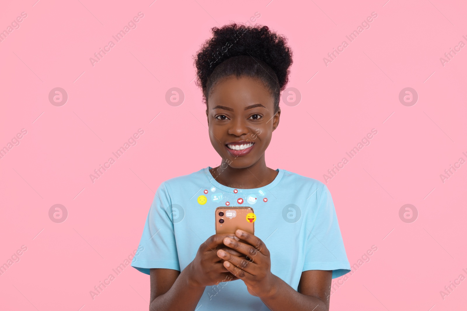 Image of Happy woman using mobile phone on pink background. New message sign and other notifications over gadget