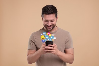 Image of Happy man using mobile phone on dark beige background. New message sign and other notifications over gadget