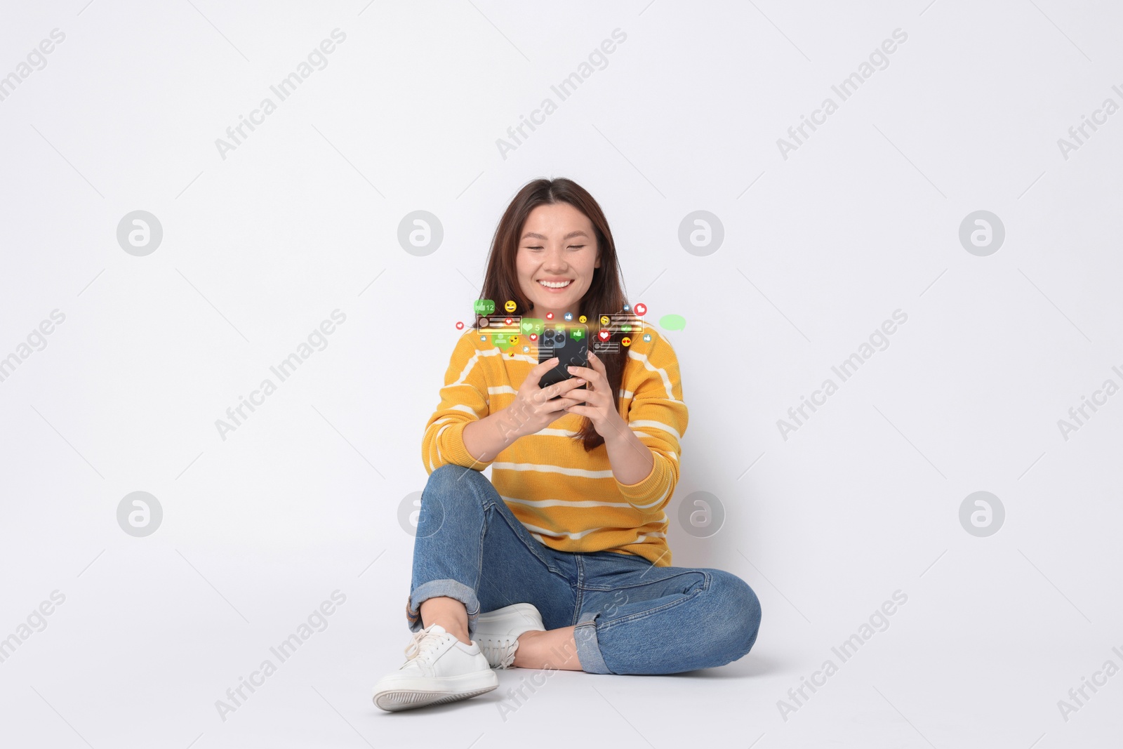 Image of Happy woman using mobile phone on white background. Different notification signs over gadget