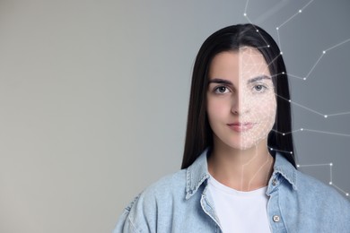 Facial recognition system. Woman undergoing biometric verification on grey background