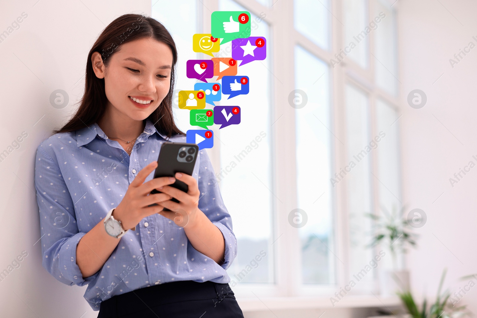 Image of Happy woman using mobile phone indoors. New message sign and other notifications over gadget