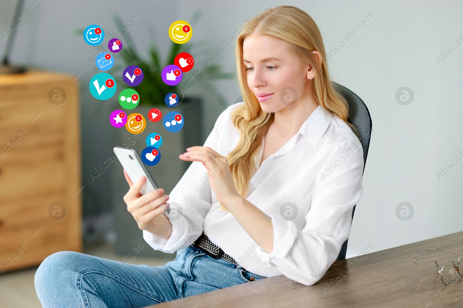 Image of Woman using mobile phone at home. New message sign and other notifications over gadget