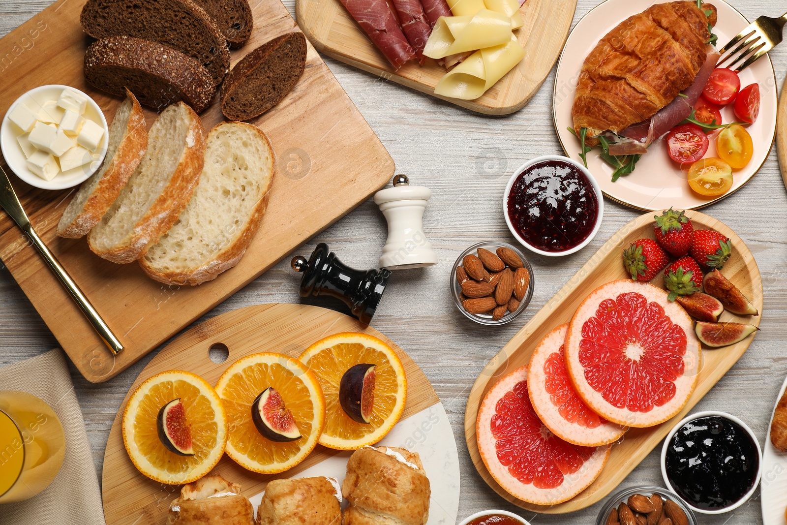 Photo of Different tasty food served for brunch on wooden table, flat lay