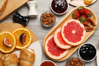 Photo of Different tasty food served for brunch on wooden table, flat lay