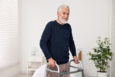 Photo of Senior man with walking frame in hospital ward