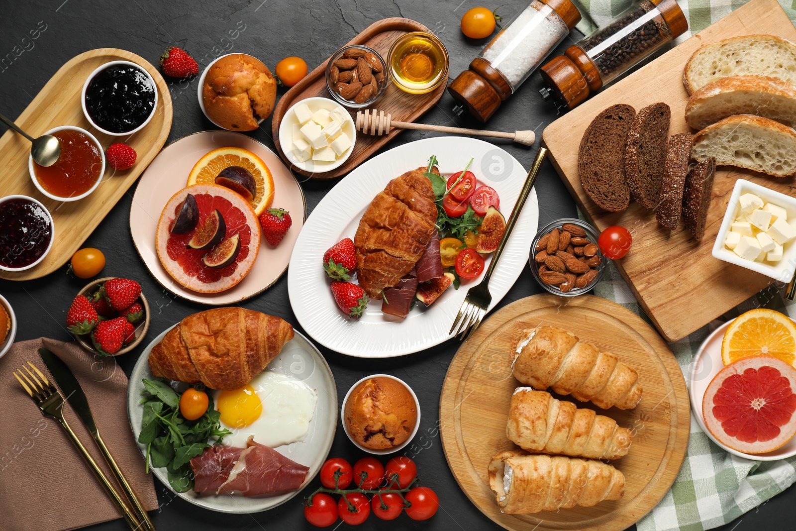 Photo of Different tasty food served for brunch on grey textured table, flat lay