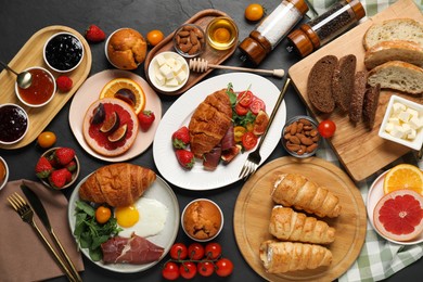 Photo of Different tasty food served for brunch on grey textured table, flat lay