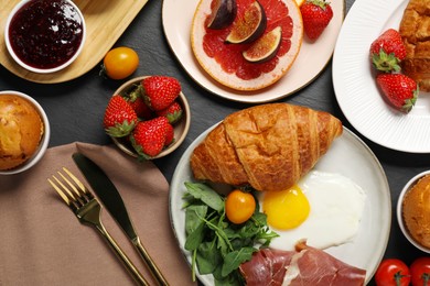 Photo of Different tasty food served for brunch on grey textured table, flat lay