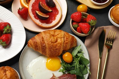 Photo of Different tasty food served for brunch on grey textured table, flat lay