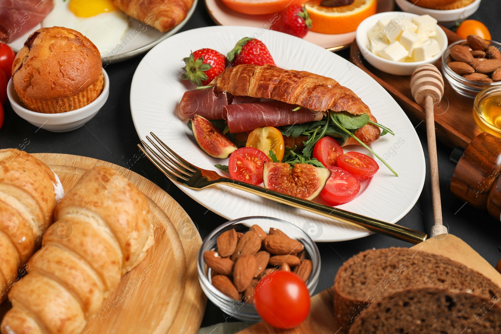 Photo of Different tasty food served for brunch on grey table, closeup