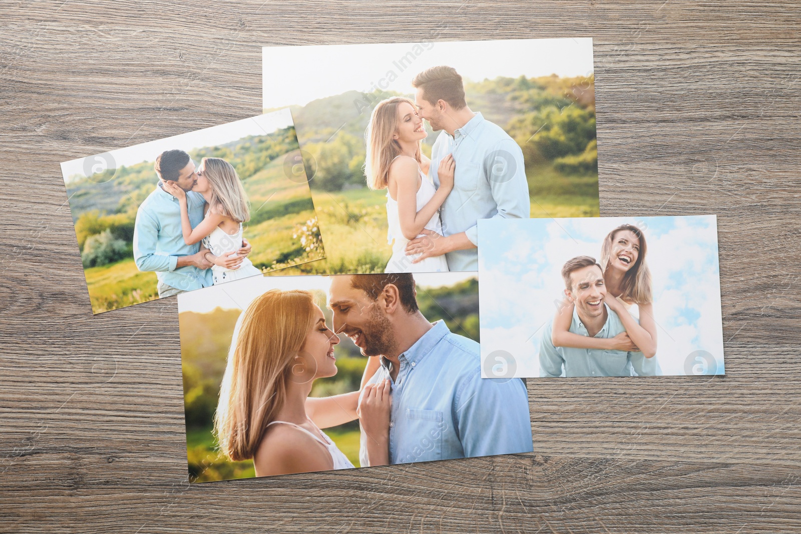 Photo of Different family photos on wooden table, flat lay