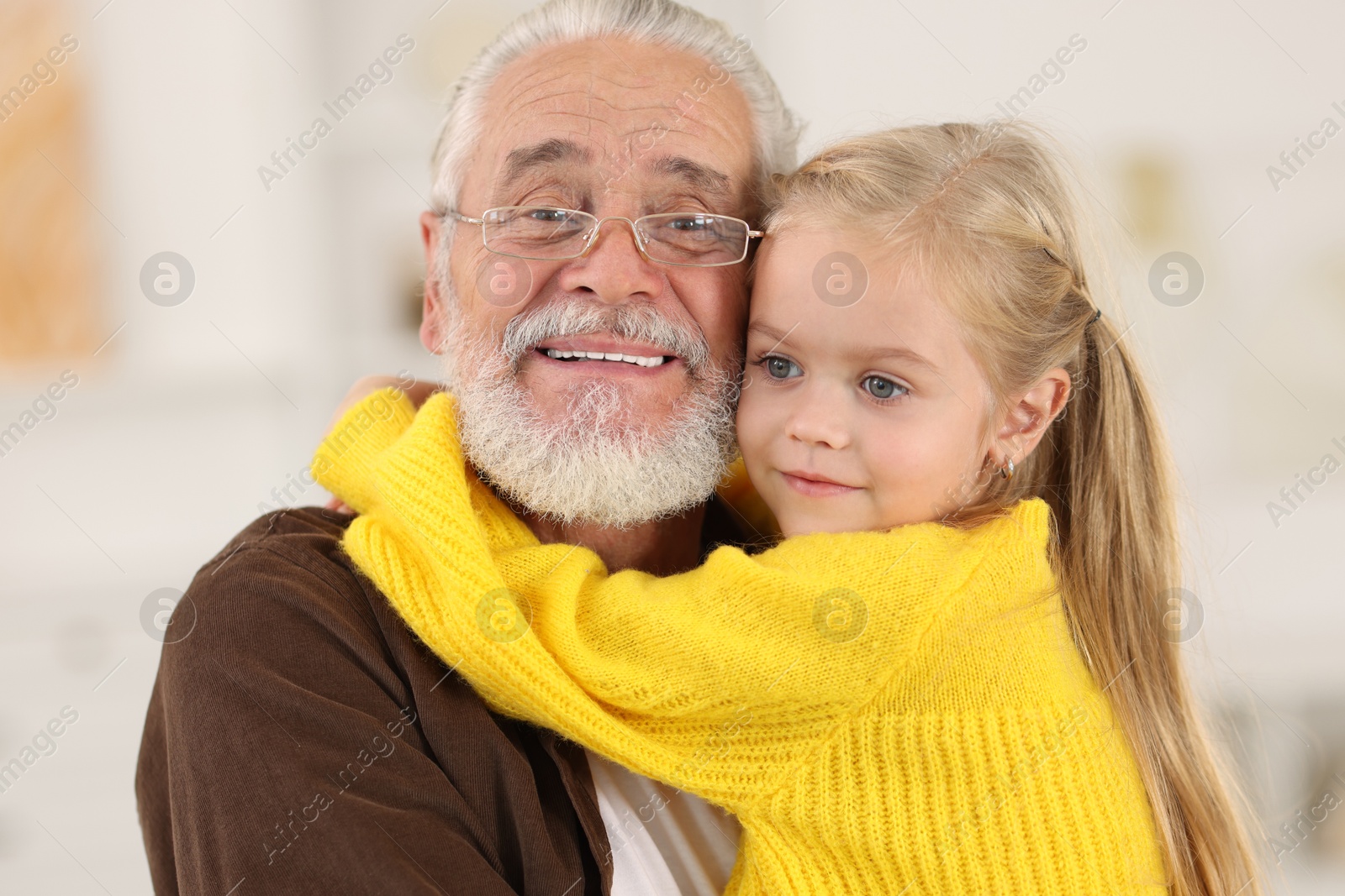 Photo of Grandpa and his granddaughter spending time together at home