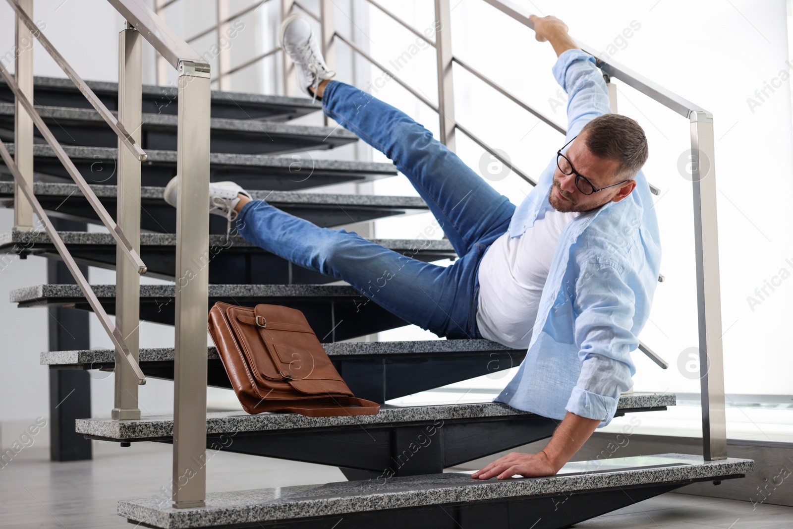 Photo of Man falling on stairs in building. Dangerous accident