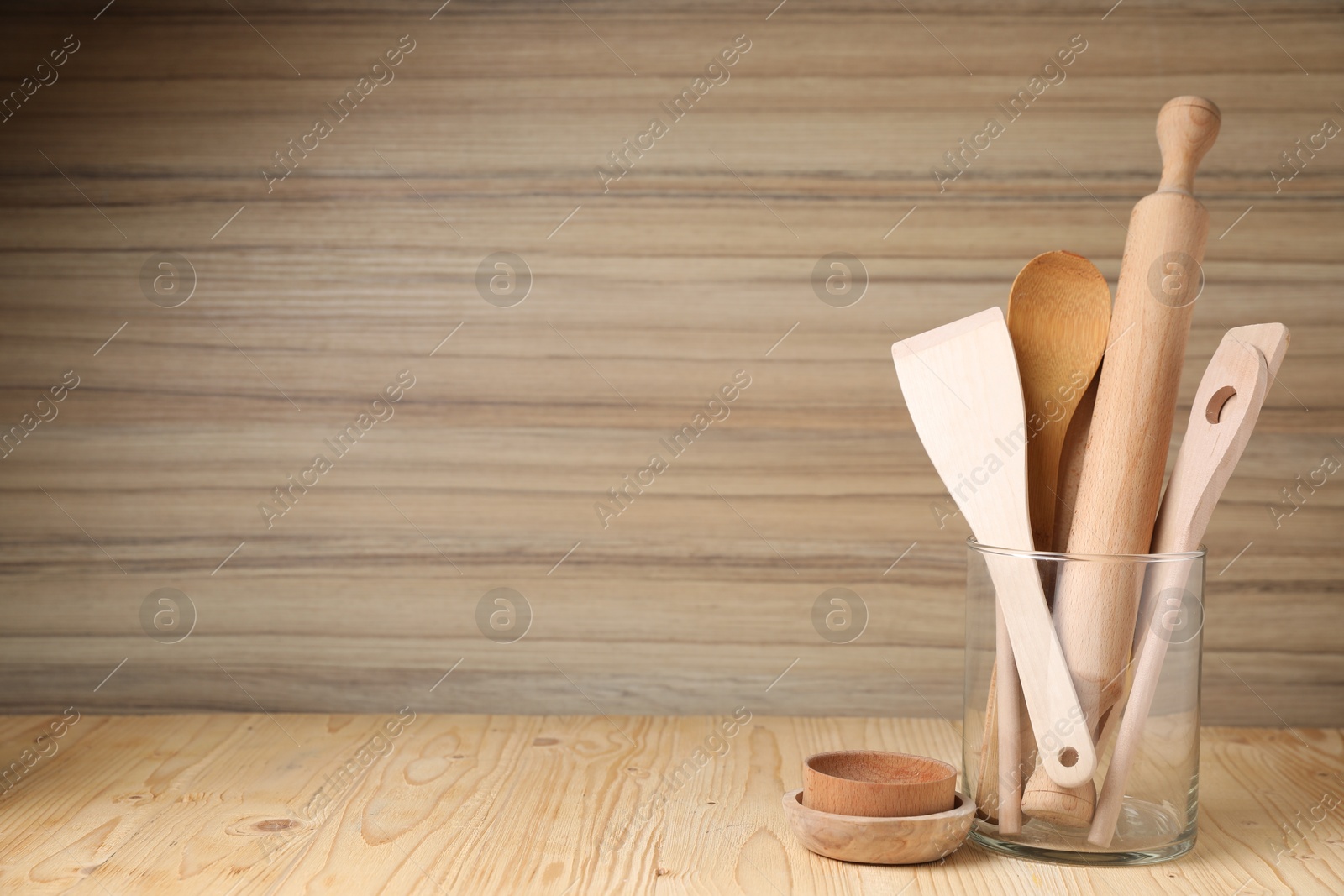 Photo of Set of cooking utensils on wooden table, space for text