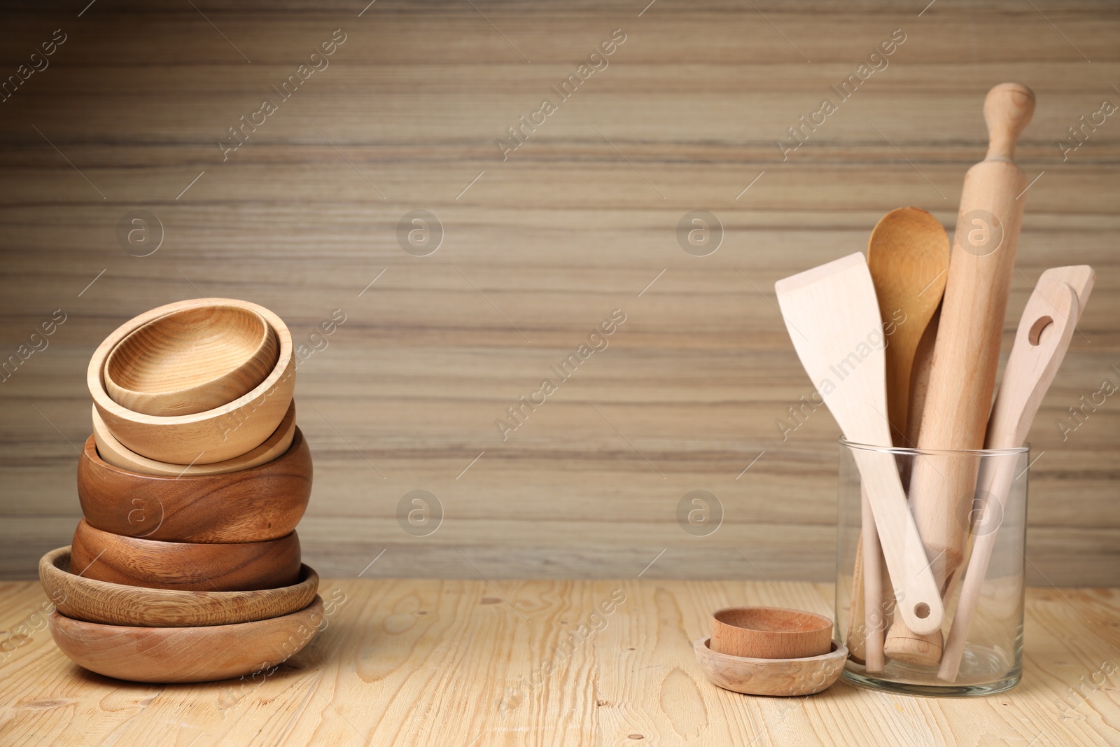 Photo of Bowls and cooking utensils on wooden table