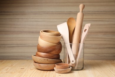 Photo of Dishware and cooking utensils on wooden table