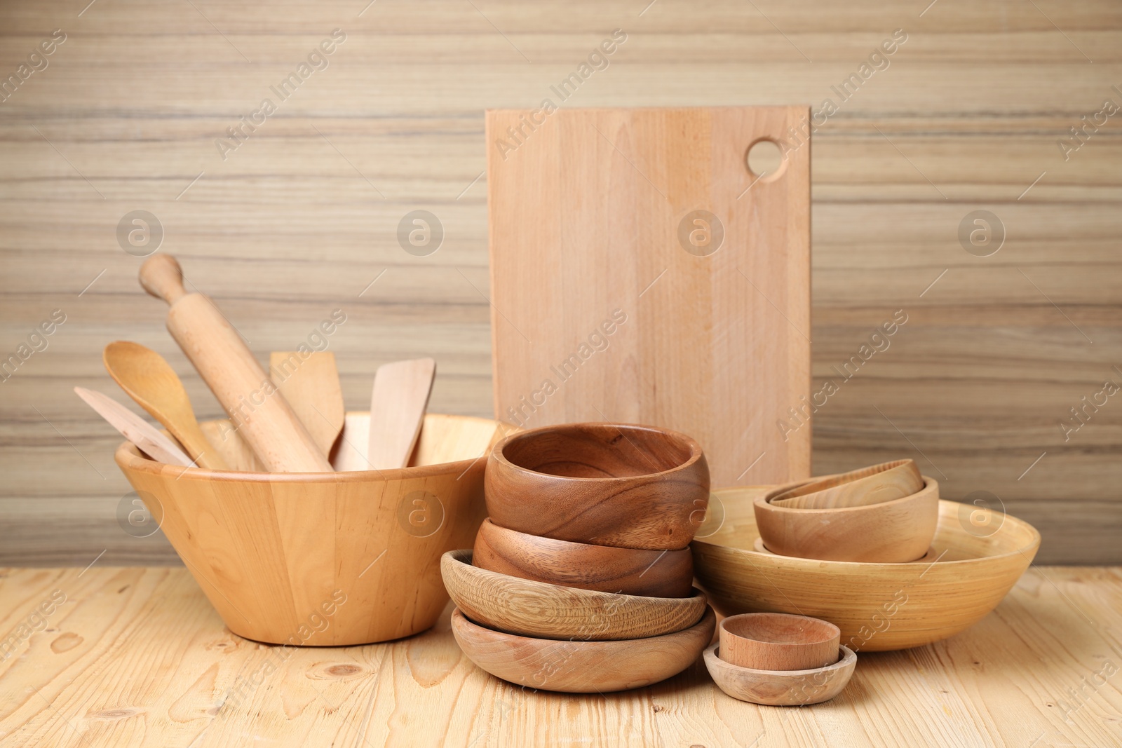 Photo of Dishware and cooking utensils on wooden table