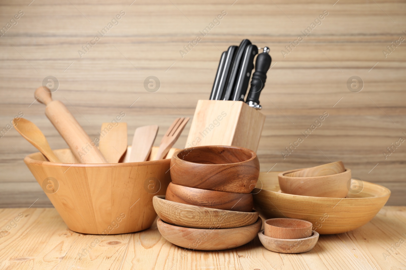 Photo of Dishware and cooking utensils on wooden table