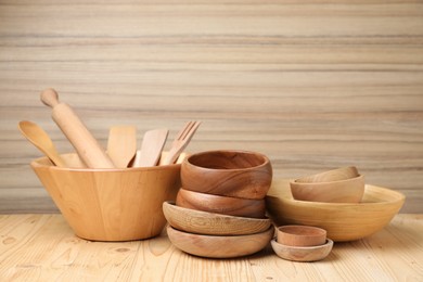 Photo of Dishware and cooking utensils on wooden table, space for text