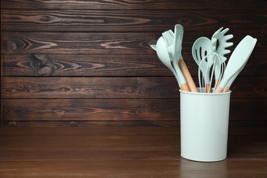 Photo of Set of cooking utensils on wooden table, space for text