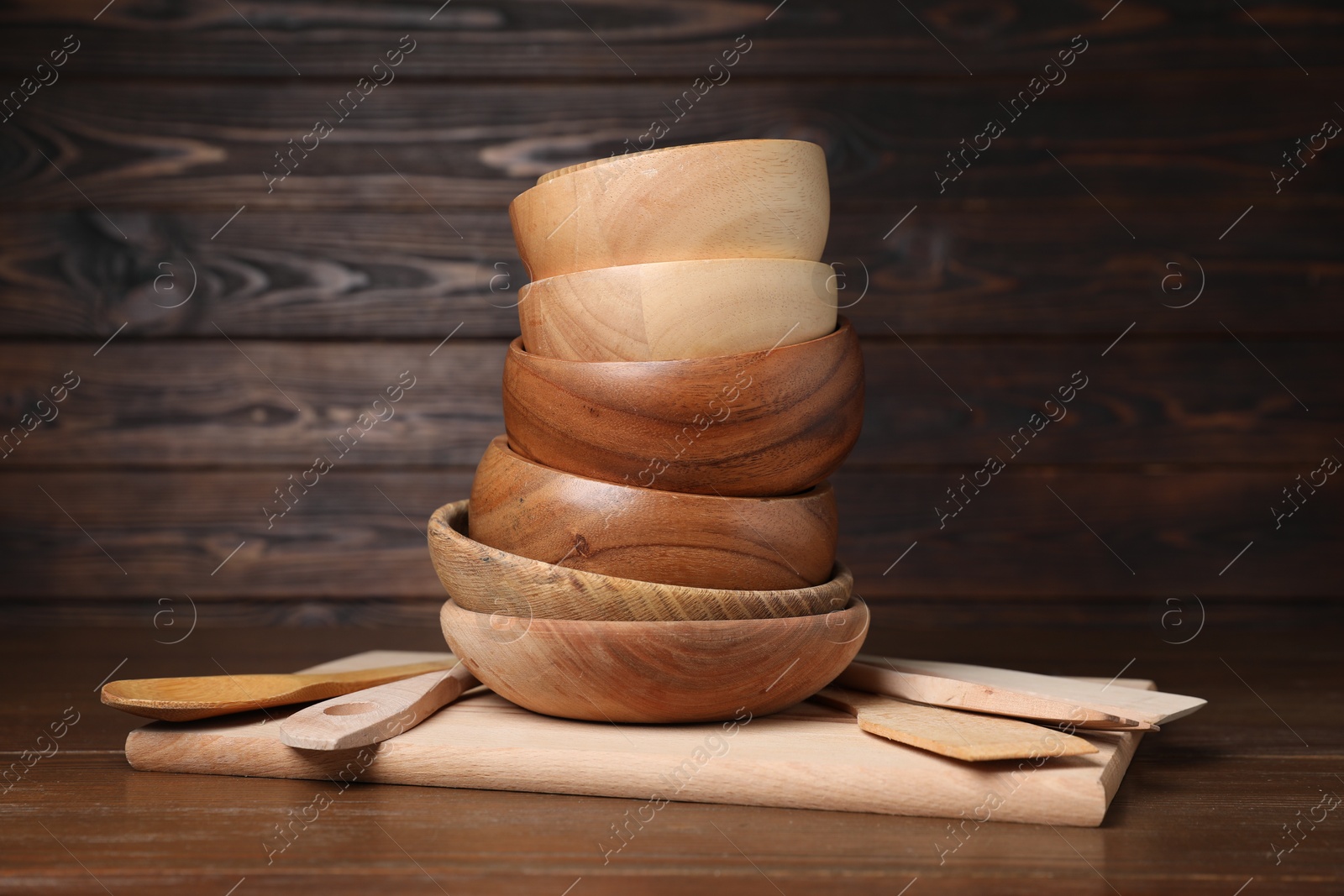 Photo of Bowls and cooking utensils on wooden table