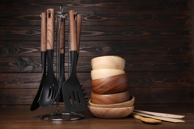 Photo of Dishware and cooking utensils on wooden table