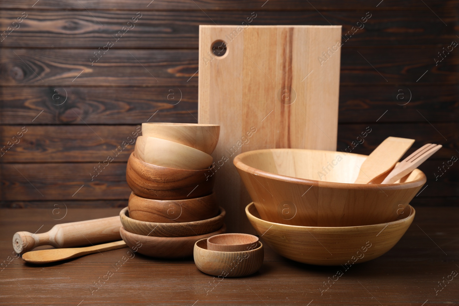 Photo of Dishware and cooking utensils on wooden table