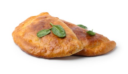 Tasty calzones with basil isolated on white