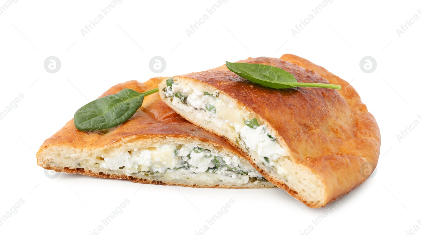 Photo of Pieces of tasty calzone with cheese and basil isolated on white