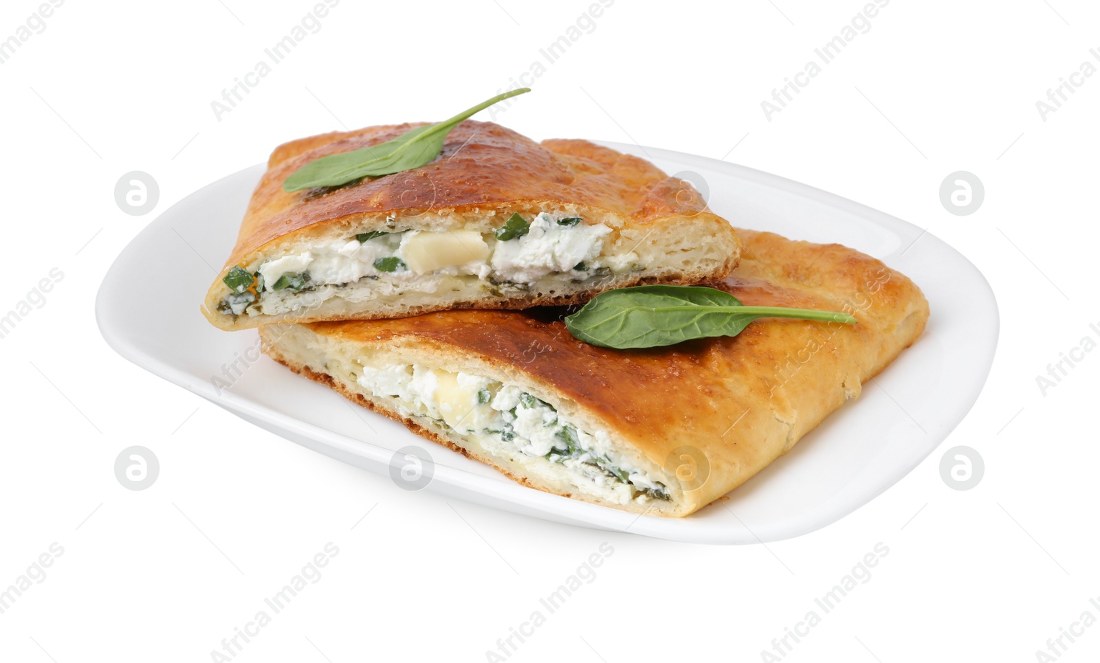 Photo of Pieces of tasty calzone with cheese and basil isolated on white