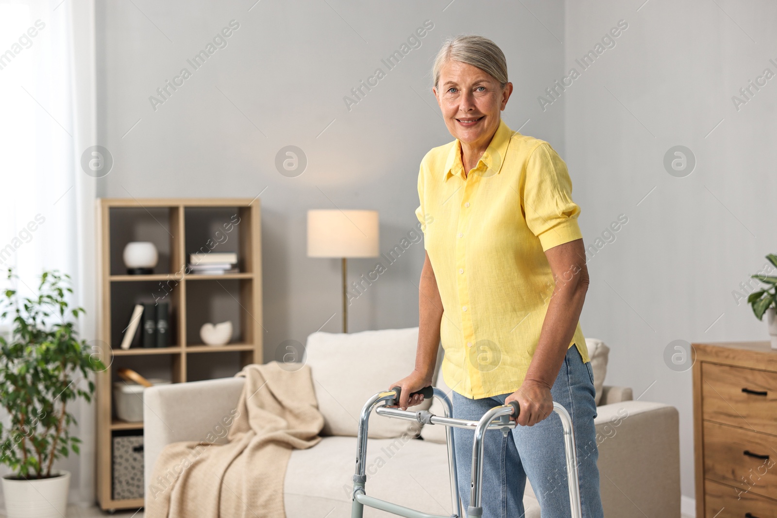 Photo of Senior woman with walking frame at home