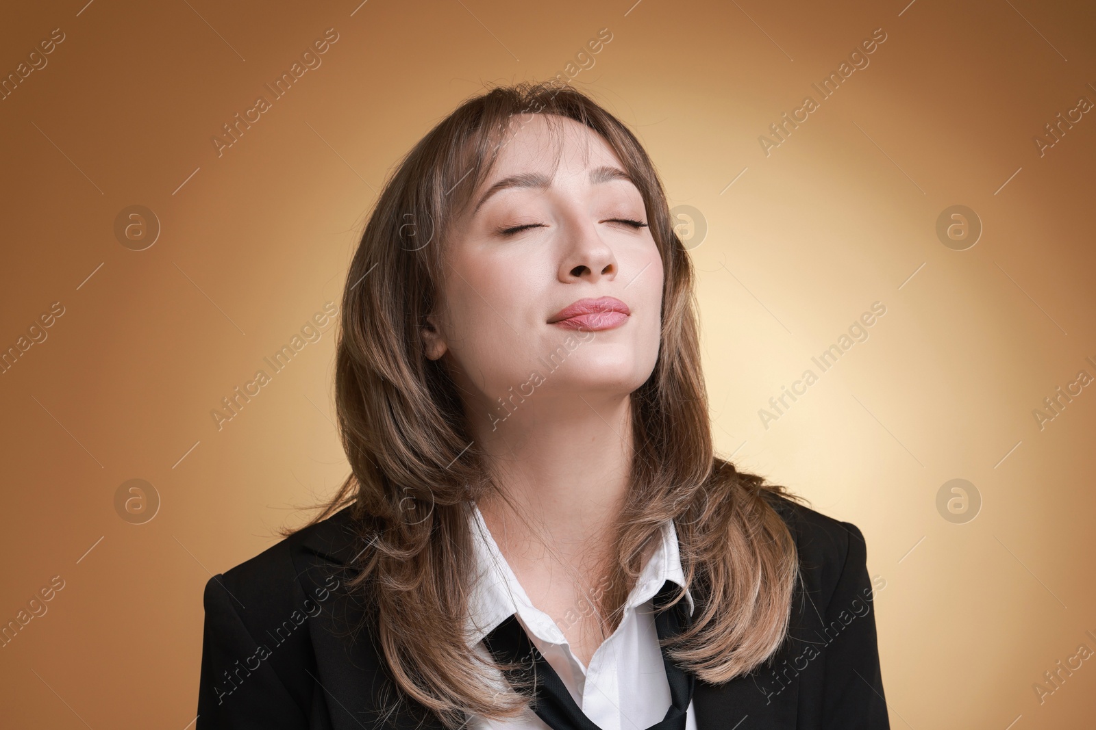 Photo of Attractive woman with stylish haircut on brown gradient background