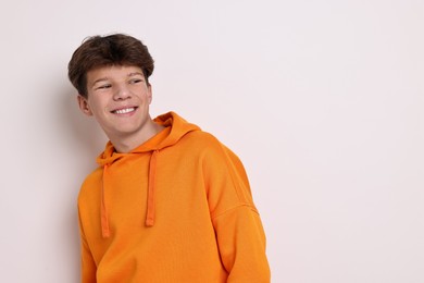 Photo of Portrait of teenage boy on white background, space for text