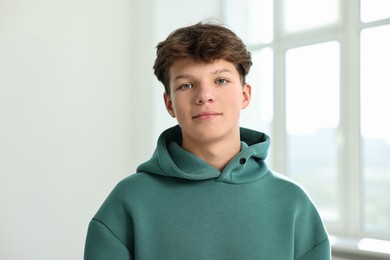 Photo of Portrait of happy teenage boy in school