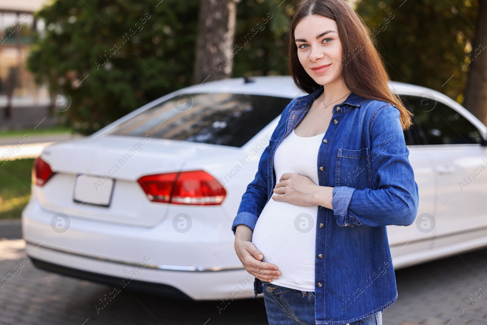 Photo of Portrait of beautiful pregnant woman near car outdoors