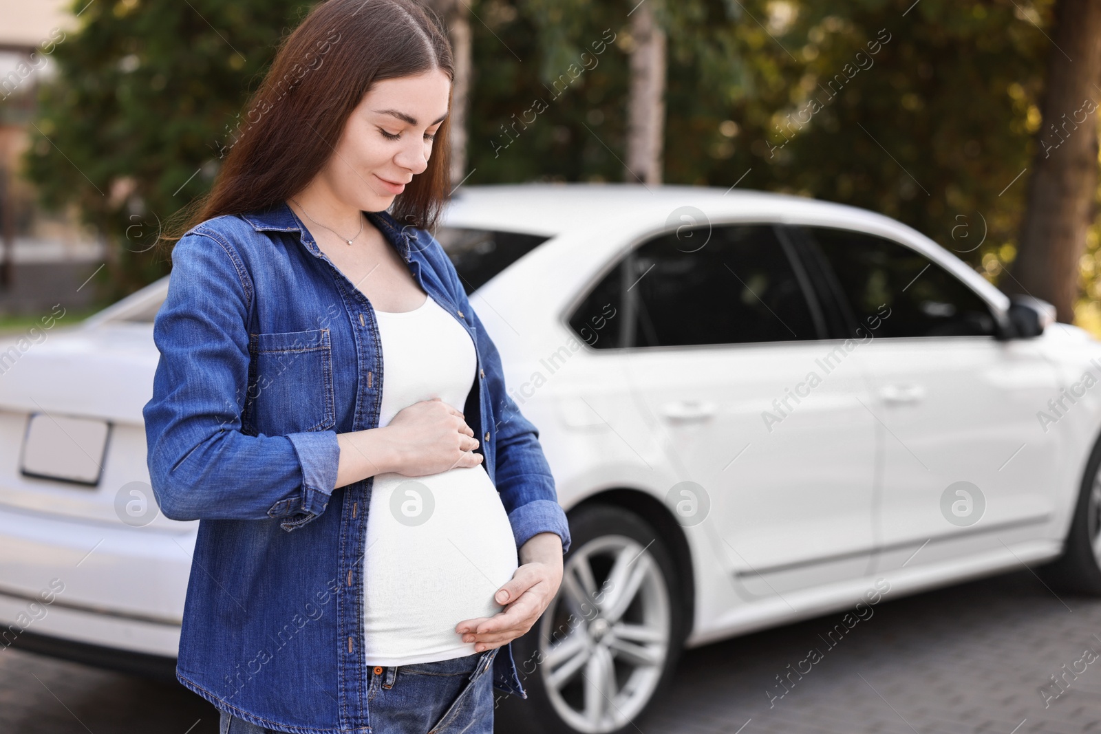 Photo of Portrait of beautiful pregnant woman near car outdoors