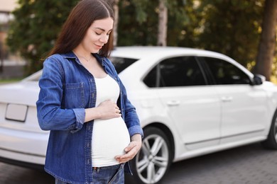 Photo of Portrait of beautiful pregnant woman near car outdoors