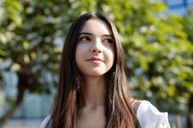 Photo of Portrait of beautiful teenage girl on city street