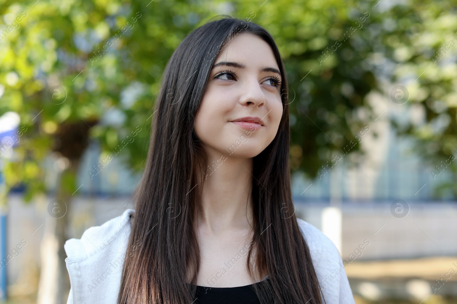 Photo of Portrait of beautiful teenage girl on city street