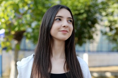 Photo of Portrait of beautiful teenage girl on city street