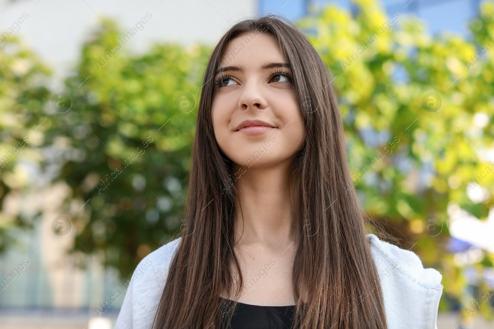 Photo of Portrait of beautiful teenage girl on city street