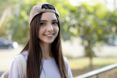 Photo of Portrait of teenage girl in stylish cap outdoors. Space for text