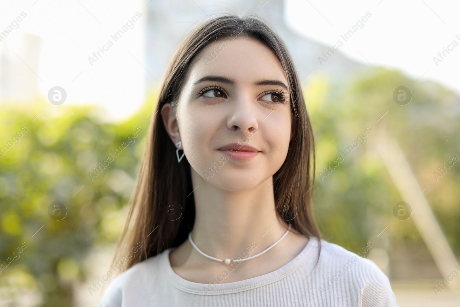 Photo of Portrait of beautiful teenage girl on city street