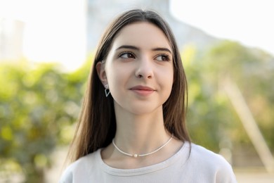 Photo of Portrait of beautiful teenage girl on city street