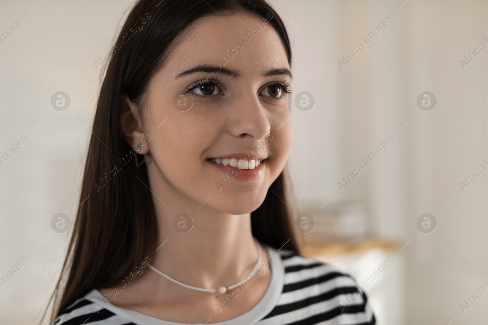 Photo of Portrait of smiling teenage girl at home